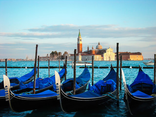 Fototapeta na wymiar Gondolas moored by Saint Mark square. View of the San Giorgio di Maggiore from Piazza San Marco - Venice, Venezia, Italy, Europe 