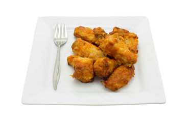 Serving of chicken wings on plate with fork