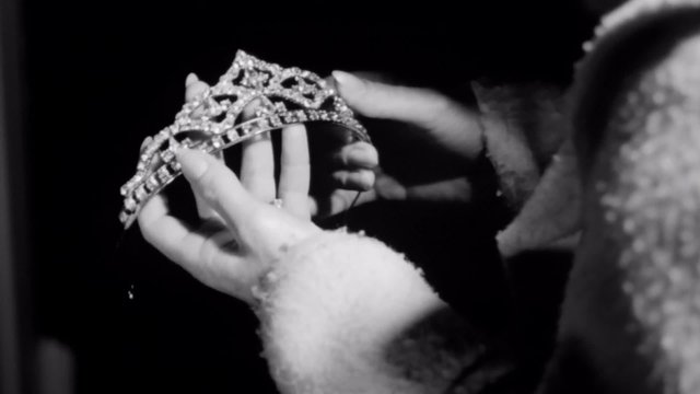 Close-up of woman examining tiara