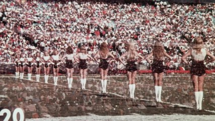 Time lapse shot of crowd watching cheerleaders at stadium