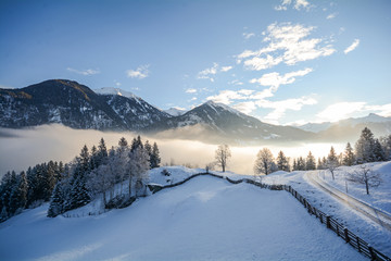 View to a winter landscape with mountain range and Gasteinertal valley near Bad Gastein, Pongau...