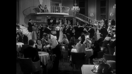 Panning shot of people in nightclub, 1940s