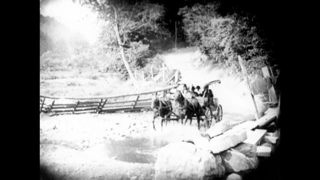 Horse cart traveling over large puddle of water, 1920s