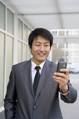 Businessman looking at cell phone