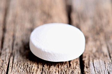 Pharmacy background. Pills on a wooden table. Medicine. Natural background. Capsule. Close up. One species of pills. Circle