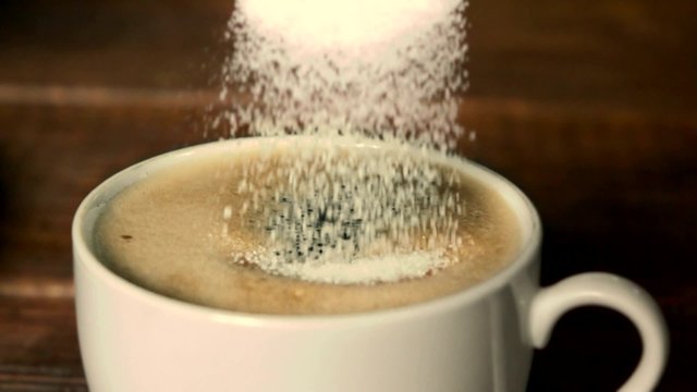 Pouring Sugar Into Coffee Cup.Slow Motion