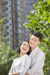 Fototapeta premium Sweet young couple arm around outdoors