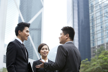 Cheerful business persons discussing with each other in Hong Kong