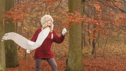 Fashion woman in windy fall autumn park forest.