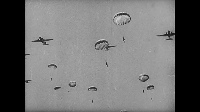Paratroopers jumping from plane, 1940s