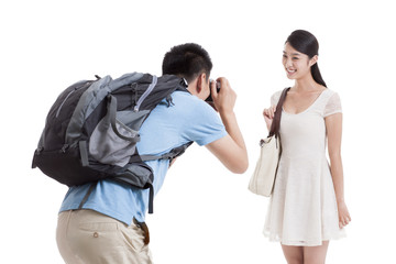 Man taking pictures of smiling wife
