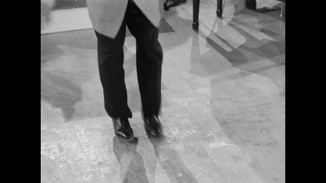 Low section of performer tap dancing, 1950s