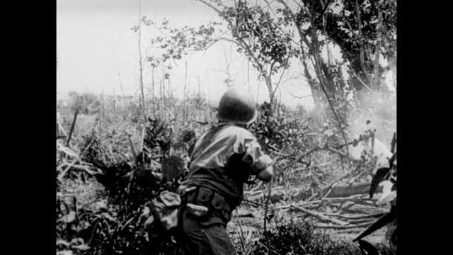 Soldiers firing into bushes, 1940s
