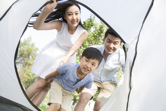 Happy young family enjoying a camping trip