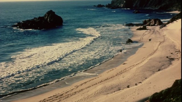High angle shot of man riding horse on the beach, 1960s