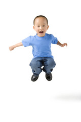 young boy jumps in the air