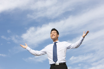 Businessman Standing with Arms Outstretched
