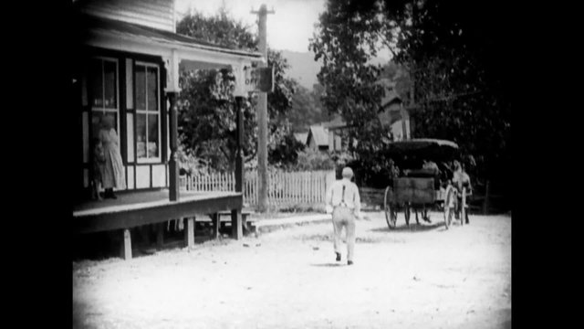 Man getting into horse cart while another man chases him