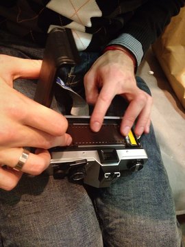 photographer repearing film slr camera