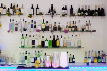 Assorted colorful bottles of alcoholic drinks in a bar