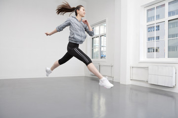 Healthy Young Woman Jumping in the Air