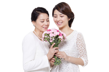 Happy daughter giving flowers to mother