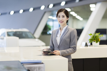 Confident receptionist at reception counter