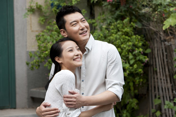 Naklejka premium Young Chinese couple embracing