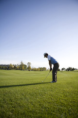 Man teeing off on the course