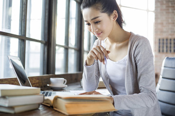 Young woman studying in cafe