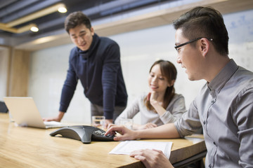 Business people having teleconference in board room