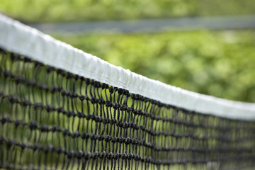 A young woman playing tennis, from behind