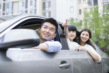 Happy young family in a car