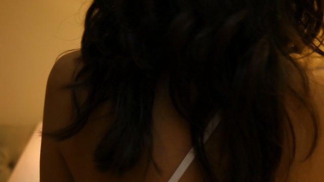 woman taking off her nightdress in a bedroom