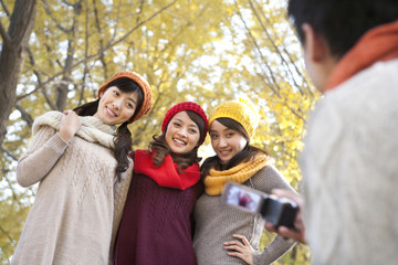Young Man Filming 3 Friends with a Home Video Camera