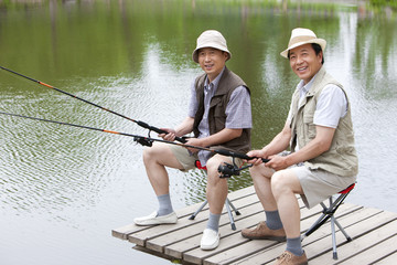 Senior friends fishing together