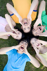 A group of young people shouting in a circle