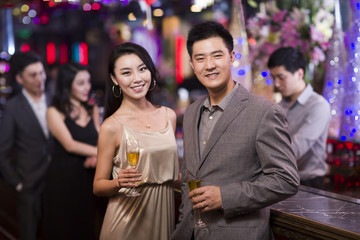 Cheerful adults drinking alcohol in bar