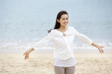 Happy young woman enjoying herself on the beach of Repulse Bay, Hong Kong