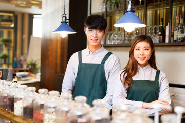portrait waitress and waiter serving in cafe