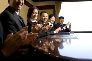 Business professionals applauding