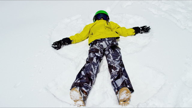 outdoor snow play young Caucasian boy activity Rockies winter vacation tourism 