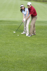 Golf coach teaching playing golf