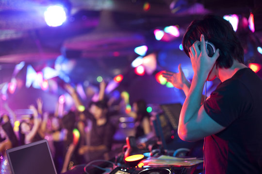 DJ doing record Scratching in nightclub