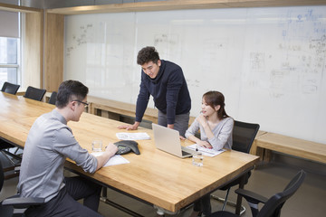 Business people having teleconference in board room