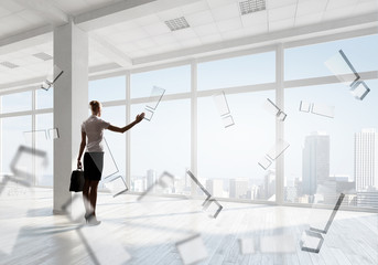 Fototapeta premium Businesswoman in top floor office