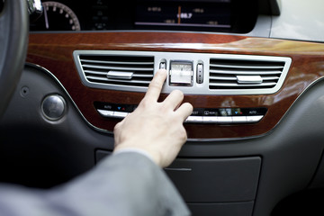 Driver adjusting car stereo