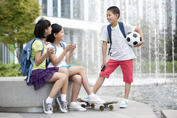 Happy school children and smart phones