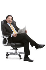 Senior businessman sitting on director's chair