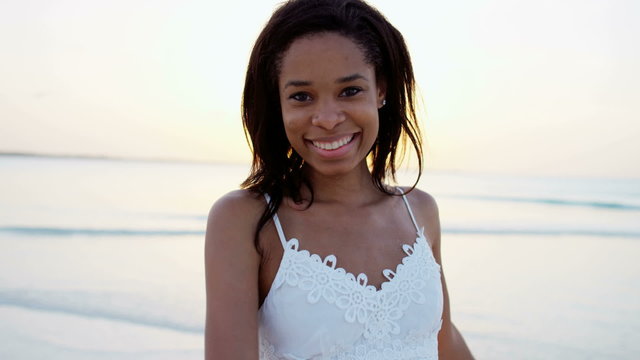 Portrait of happy African American girl on ocean beach 